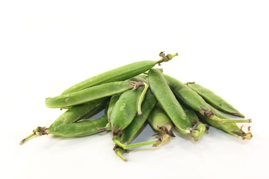 fresh green peas on a white background
