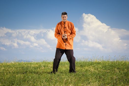 A man doing Qi-Gong in the green nature