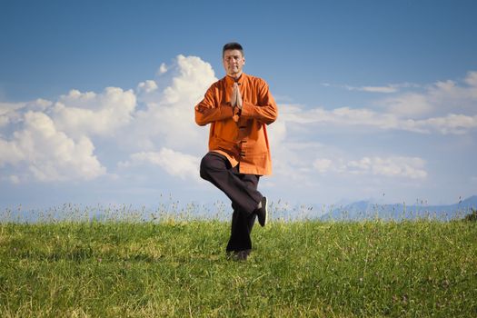 A man doing Qi-Gong in the green nature