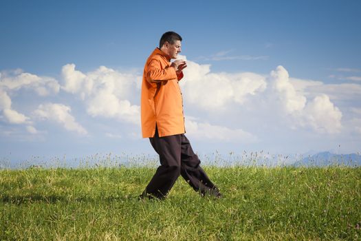 A man doing Qi-Gong in the green nature