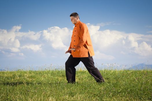 A man doing Qi-Gong in the green nature