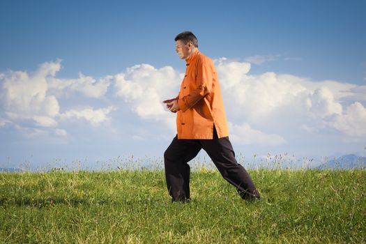 A man doing Qi-Gong in the green nature