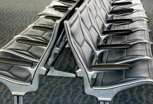 Airline terminal waiting room seats inside an airport.