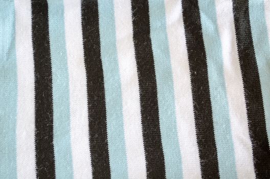 background of woolen pullover pattern. white black blue vertical color lines fabric texture.