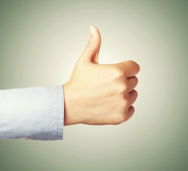 Giving thumbs up or like on green background