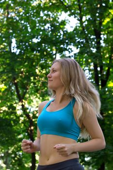 Girl running in the park along trees