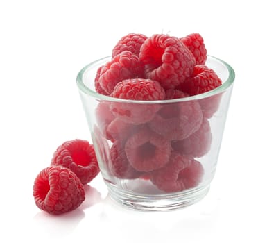 Some raspberries in the glass on the white background