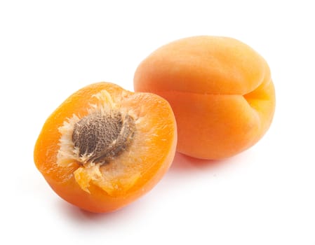 Whole and half apricot with clingstone on the white background