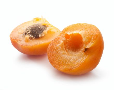 Two half of apricot with one clingstone on the white background