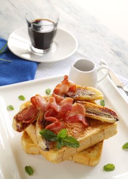 French toast with bacon and caramalized banana with maple syrup.