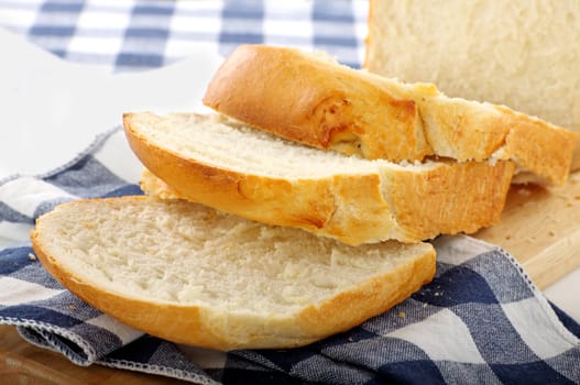 Fresh crusty bread just sliced and ready to serve.