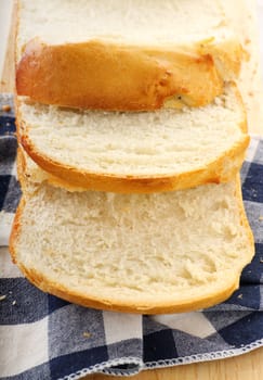 Fresh crusty bread just sliced and ready to serve.