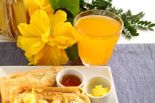 Freshly squeezed orange juice with toast for breakfast.