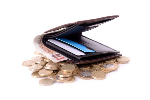 a wallet on a pile of pound coins isolated on white