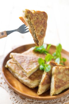 Malaysian food murtabak usually sold in Indian Muslim restaurants and stalls , stuffed with minced mutton, garlic, egg and onion, and is eaten with curry gravy.
