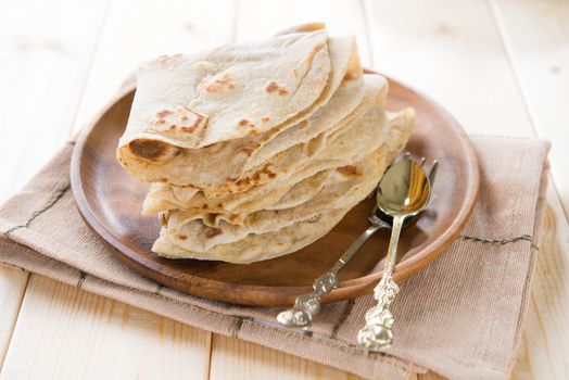 India vegetarian food plain chapatti roti or Flat bread. Indian food on dining table.
