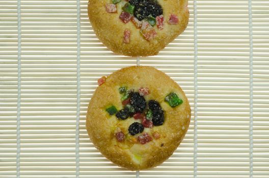 two sweet bread with raisin and  dried fruits  on wooden background