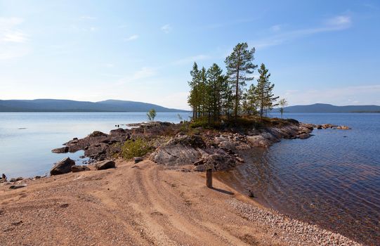 A picturesque lake with a pebble beach in the north of Russia. Tolvand lake. Iovskoe reservoir. Karelia
