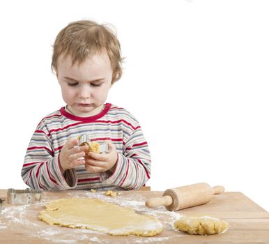 young child with rolling pin and dough. Isolated on white background