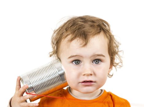 young caucasian child with tin can phone looking to camera