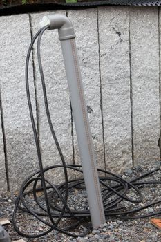 Installing electrical cables through a metal pipe running underground on a new build construction site