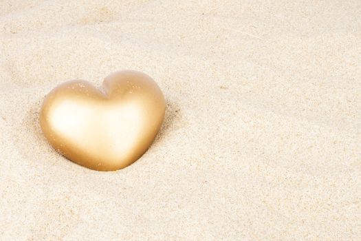 Golden heart in the sand