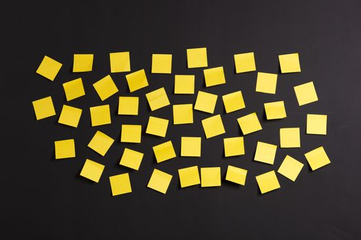 Background image of yellow notes on a black board