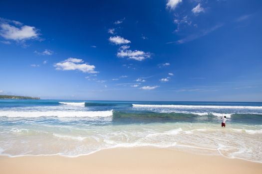 A fishermanon a beautiful white sand tropical beach 