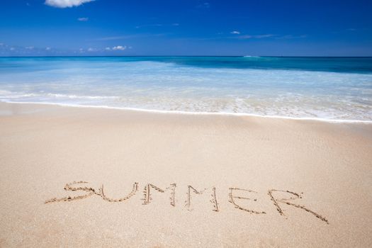 Beautiful tropical beach with the word summer written on the sand