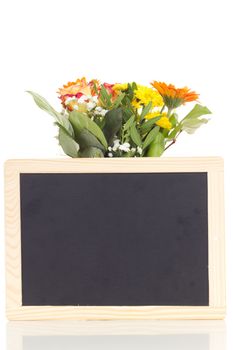 Bunch of flowers with blank blackboard
