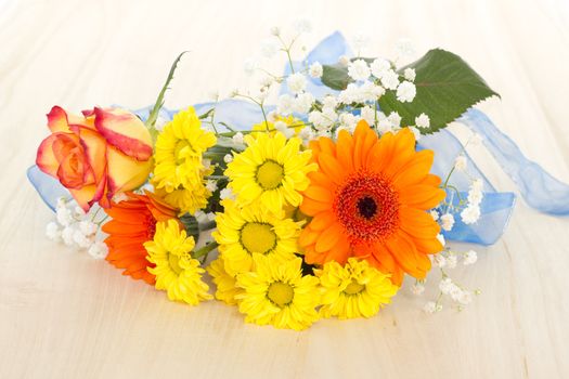 Bouquet of beautiful mixed flowers on wooden background