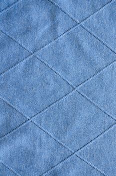 background of cross lines on knitted blue sweater pattern fabric.