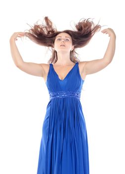 Portrait of a beautiful young woman in blue dress with streaming hair on white background