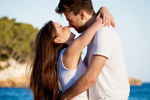 attractive young couple in love summertime on beach smiling romance