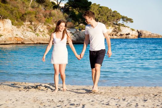 attractive young couple in love summertime on beach smiling romance
