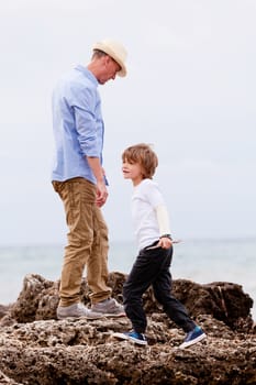 father and son playing outdoor on beach summer vacation holiday 