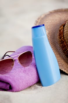 sunprotection objects on the beach in holiday sunglasses hat suncare