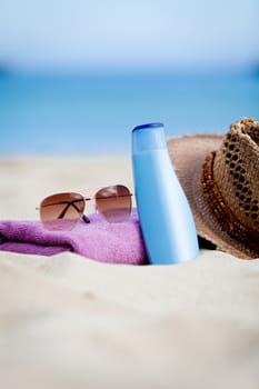 sunprotection objects on the beach in holiday sunglasses hat suncare