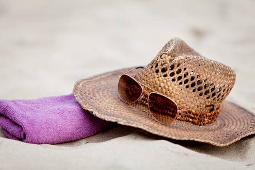 sunprotection objects on the beach in holiday sunglasses hat suncare