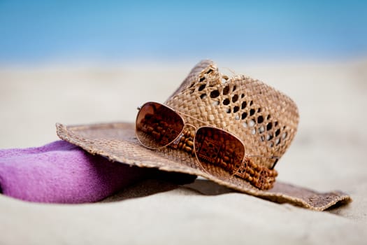 sunprotection objects on the beach in holiday sunglasses hat suncare