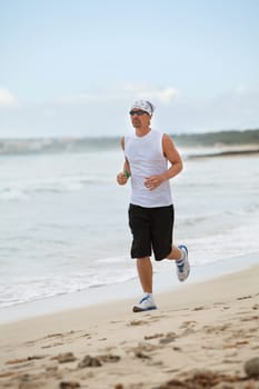 man is jogging on the beach summertime sport fitness run jogger runner