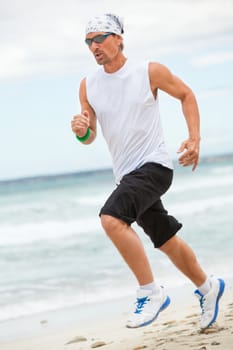 man is jogging on the beach summertime sport fitness run jogger runner