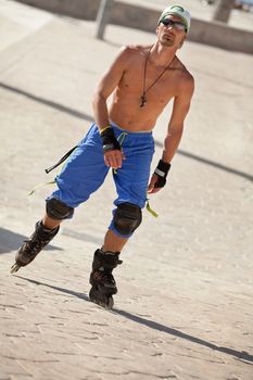 young man with inline skates in summer outdoor rollerblades skater