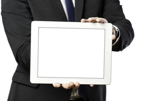 business man in dark suit holds a tablet computer, isolated on white background