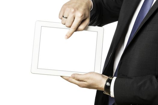 Business man in black suit shows something on his tablet computer, isolated on white background