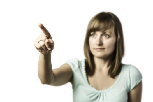 Young pretty girl shows a finger at something, isolated on white background