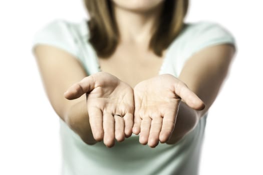 Young woman stretches out her empty hands, isolated on white backgrounds