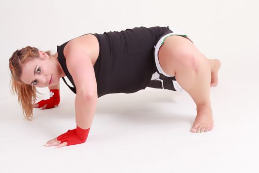 Blonde young woman doing push-ups