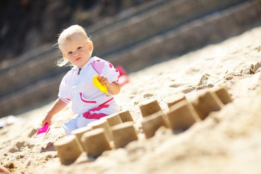 playing on the sand small child