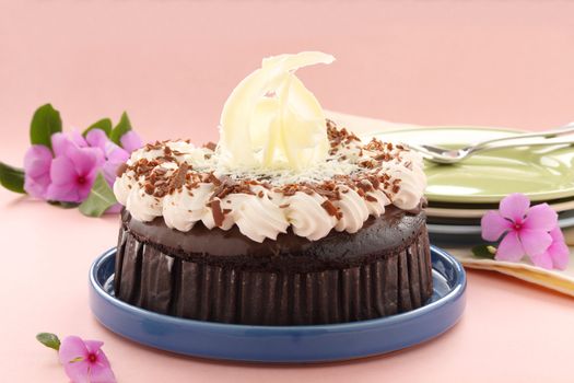 Deicious rich chocolate mud cake with white chocolate garnish sculpture.